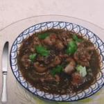 Assiette de rognons de veau à la sauce balsamique, garnie de persil et coriandre