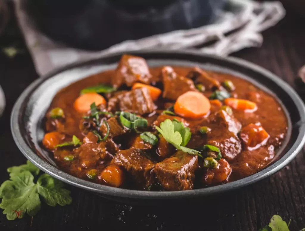 Assiette de daube provençale de grand-mère servie avec un morceau de pain de campagne pour saucer la sauce riche.